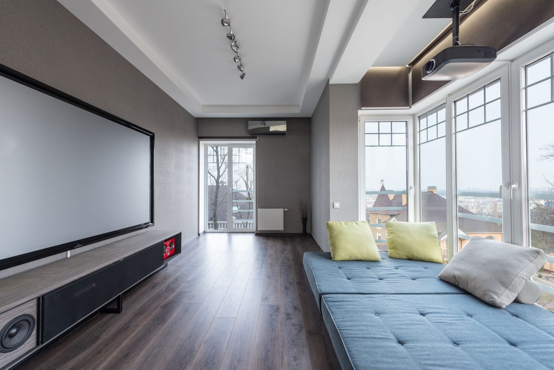 A bright media room with a large projector screen