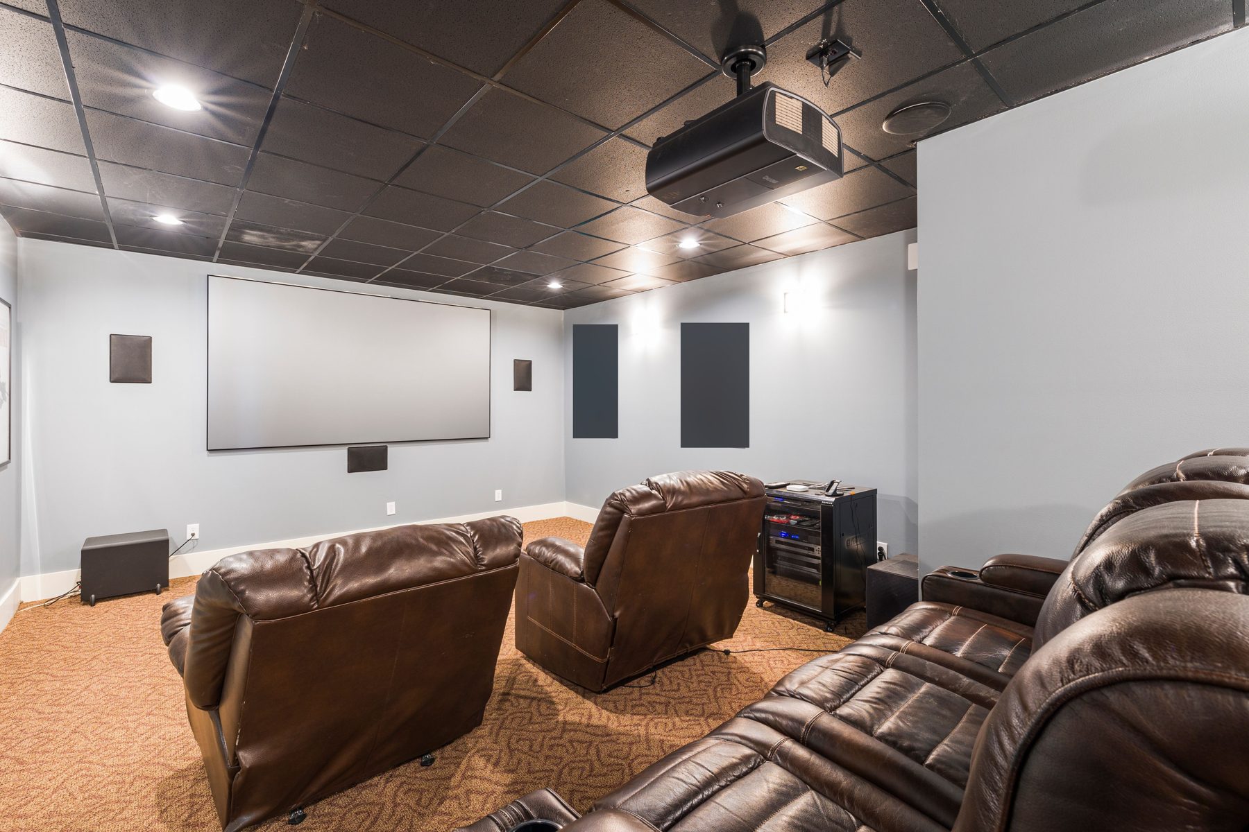 A private home theatre with a projector and screen