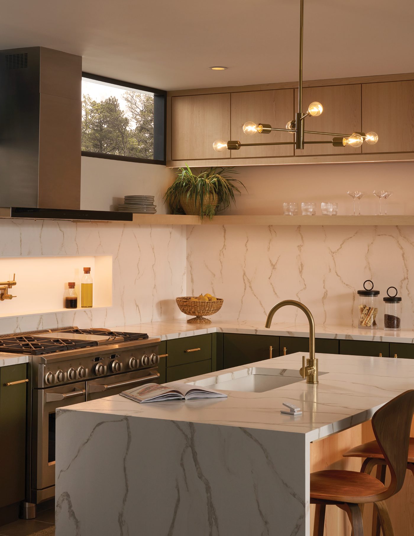 Kitchen with marble island, pendant lights and warm under-cabinet light