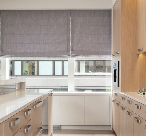 Roman shades by Lutron in a furnished room