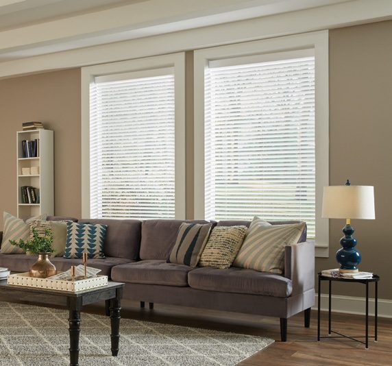 Wood blinds by Lutron in a furnished room